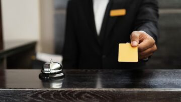 Pessoa segurando cartão em balcão de hotel